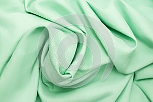 Close-up texture of light green fabric or cloth. Light green fabric texture of background. Crumple light green fabric