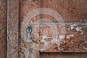 Close-up texture of old dark wooden entrance. Background of rough distressed door leafs. Shabby scratched natural timber