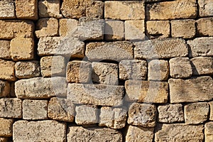 Close up texture of old yellow shell rock wall