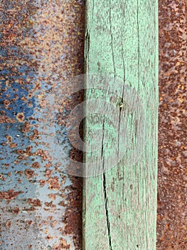 Close-up texture of peeling green paint on a wooden surface