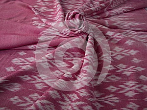 Close up of texture of pink color hand woven cotton fabric