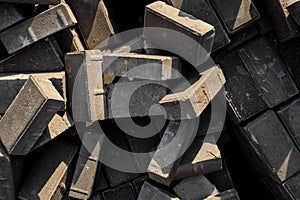 Close up texture of randomly scattered grey building bricks