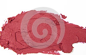 Close-up of the texture of red lipstick. A sample of lipstick on a white background. Fashion and beauty concept.