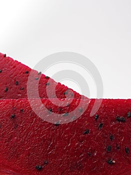 Close up texture of ripe sliced pink pitaya also called  dragon fruit isolated on white background.