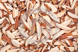 Close up texture of roasted slice almond and some powder on peel