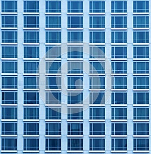 Close-up texture view of a blue skyscraper with many windows