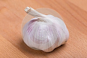 Close up texture of white and fresh raw garlic bulbs place on wooden table, valuable herbal for healthiness.