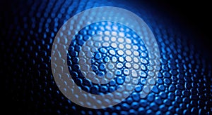 Close up textured blue surface with hexagonal pattern and dramatic lighting