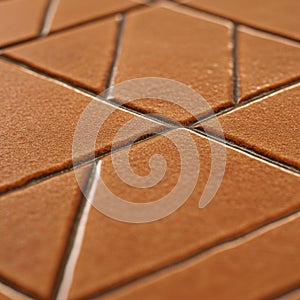 Close-up of a textured ceramic tile surface featuring a geometric pattern of