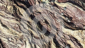 Close-up of textured rock surface with layered geological formations