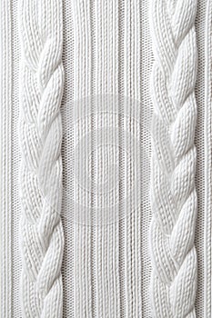 Close-up of textured white cable knit fabric pattern