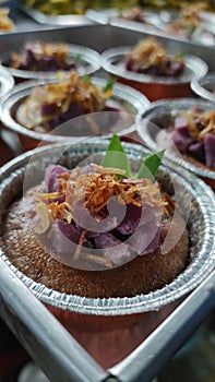 Close up Thai dessert, Coconut custard with purple sweet potatoes in Floyd cup, delicious and beautiful.