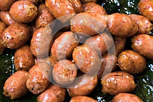 Close up of Thai Isaan style sausages on banana leaf