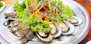 Close up Thai papaya style and vegetable salad with seafood, fresh mussel, prawn and blue crab