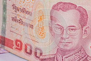 Close up of thailand currency, thai baht with the images of Thailand King. Denomination of 100 bahts