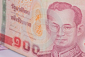Close up of thailand currency, thai baht with the images of Thailand King. Denomination of 100 bahts photo