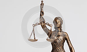 close up of Themis goddess of justice statuette on light background. symbol of law