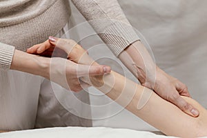 close up therapist massaging patient s arm. High quality photo