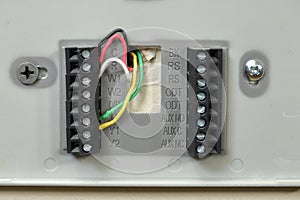 Close-up of thermostat wiring on wall