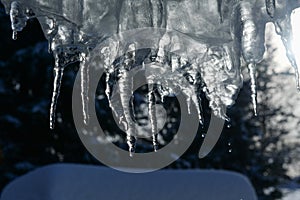 close up of thick blue ice and many icicles