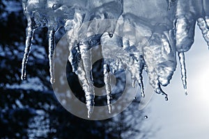close up of thick blue ice and many icicles