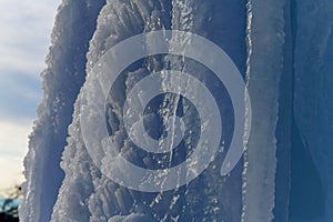 close up of thick blue ice and many icicles