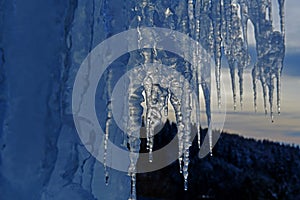 close up of thick blue ice and many icicles