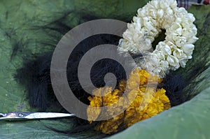Close up things on lotus leaf during tonsure on ordination ceremony.