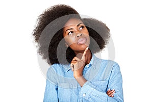 Close up thinking young black woman with afro looking up at copy space