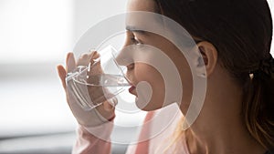 Close up of thirsty girl enjoying pure mineral water photo