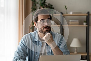 Close up thoughtful businessman wearing glasses looking to aside