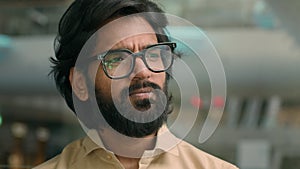 Close up thoughtful pensive 30s Arabian bearded businessman in glasses looking away thinking pondering business idea