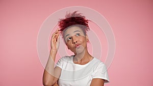 Close up thoughtful smiling African American redhead woman looks away thinking