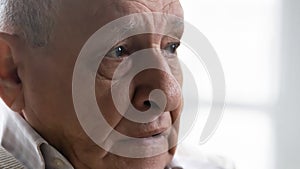 Close up thoughtful upset elderly man feeling lonely and depressed