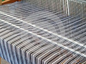Close-up thread on loom, traditional hand weaving with retro loom machine