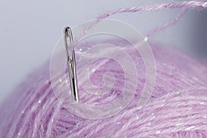 Close up of thread through a needle