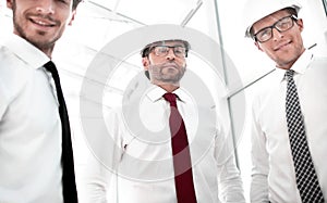 close up.three businessman in a protective helmet