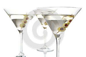 Close-up three classic dry martini with olives isolated on white