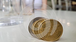 Close Up of Three Euro Coins Standing on White Glossy Table