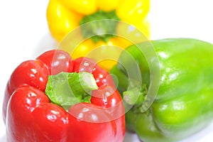Three fresh sweet peppers on white background