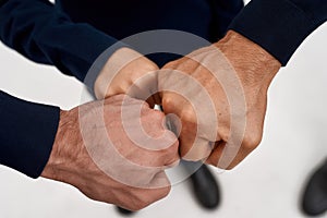 Close up of three generations of men give fists bump