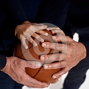 Close up of three generations of men hands on ball