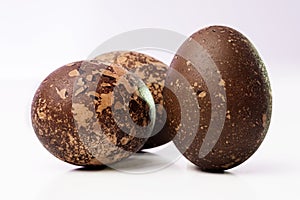 Close-up of three grungy colored Easter eggs on white