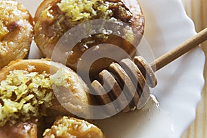 Close up of three lemon cakes and honey