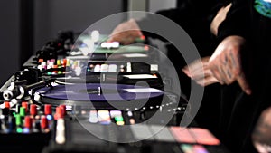 Close up of three men DJs playing electronic party music on vinyl cd usb player in the studio. Art. Side view of male