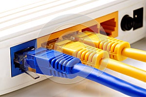 Close up on network cables connected to WAN and LAN ports on router