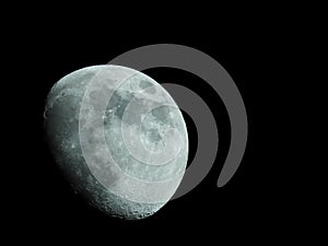 Close-up of a three-quarter moon in the night sky