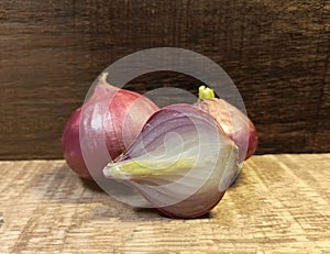 Close up three red onion on wooden background