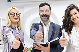 Close up of three workers in office.