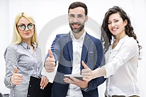 Close up of three workers in office.